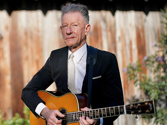 photograph of Lyle Lovett with a guitar